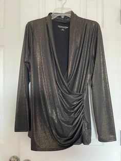 "Elevate your wardrobe with this stunning Soft Surroundings black and gold metallic faux wrap top blouse. Perfect for any occasion, this classic tunic style blouse features a flattering V-neckline.The solid pattern in black and metallic gold adds a touch of glamour to your look, while the polyester material makes it packable and easy to wear all year round. This large sized blouse is in great used condition, suitable for casual wear, workwear, business, and even party/cocktail events. The blouse is a must-have for any fashion-conscious woman who wants to look stylish without compromising on comfort. Get your hands on this Soft Surroundings blouse today and take your fashion game to the next level! Measurements with pictures: Armpit to armpit 22\" Waist 18\" Hip 21\" Long 28\" Sleeve 25\"" Fall Night Out Tops With Surplice Neckline, Fall Night Out Top With Surplice Neckline, Fall Tops With Surplice Neckline For Night Out, Faux Wrap Top For Night Out In Fall, Formal Wrap Top For Fall, Elegant Wrap Blouse For Night Out, Formal Fall Wrap Top, Chic Faux Wrap Blouse For Night Out, Elegant Top With Surplice Neckline For Night Out