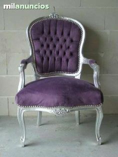 a purple chair sitting in front of a brick wall with the words millanincios written on it