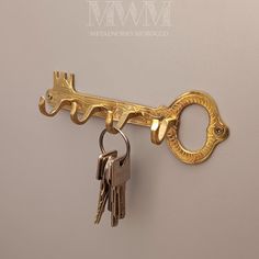 a golden key is hanging on the wall