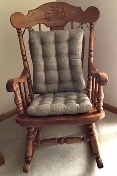 a wooden rocking chair with a cushion on it