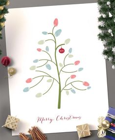 a christmas card with an image of a tree and presents on the table next to it