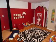 a child's playroom with red walls and white trim