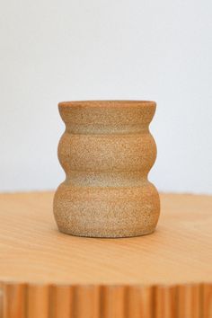 a small vase sitting on top of a wooden table