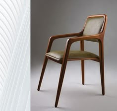 a wooden chair sitting next to a window with blinds on it's sides and an image of the same chair