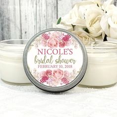 personalized bridal shower candle with pink flowers on it next to a white rose bouquet