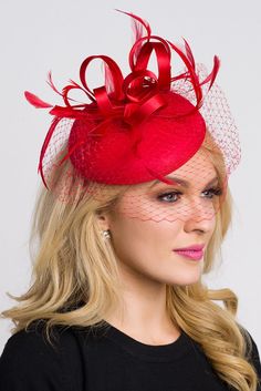 Be the envy of the party in this elegant felt fascinator. The round felt base is covered with satin ribbon loops, adorned with flighty feathers and topped off with a birdcage veil. This gorgeous piece is perfect for any special occasion. - Easy wear headband - Optional; tuck-a-way veil - Available in several other colors Felt Fascinator, Red Fascinator, Derby Outfits, Unique Hair Accessories, Red Hat Society, Spring Hair, Fascinator Headband, Birdcage Veil, Derby Party