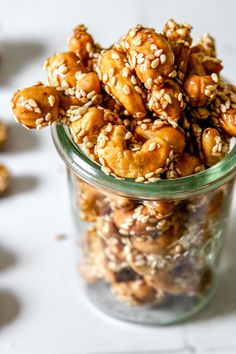 a glass jar filled with nuts on top of a table