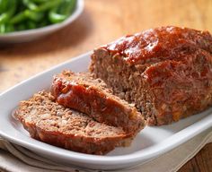 meatloaf on a white platter with ketchup