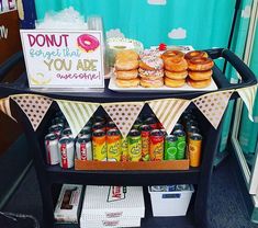 a cart with donuts and drinks on it