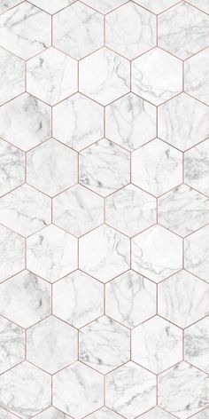 a white marble tile wallpaper with hexagonal tiles in the middle and gold lines