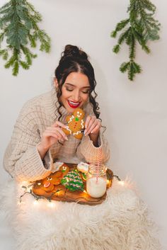 a woman sitting at a table eating a gingerbread