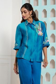 Peacock blue chanderi shirt with placed floral crochet embroidery. Comes with matching pant.
Components: 2
Pattern: Embroidered
Type Of Work: Crochet
Neckline: Shirt Collar
Sleeve Type: Full
Fabric: Shirt: Chanderi, Pant: Italian Cotton, Lining: Mulmul
Color: Blue
Other Details: 
Attached lining
Weight: 250 grms
Closure: Shirt: Front button
Occasion: Party,Work - Aza Fashions Blue Resham Embroidery Palazzo Set For Summer, Blue Pant Set With Resham Embroidery, Spring Blue Chanderi Sets, Traditional Blue Pant Set With Floral Embroidery, Spring Designer Wear Blue Sets, Designer Spring Blue Set, Blue Embroidered Long Sleeve Pant Set, Festive Blue Pant Set, Blue Chikankari Embroidery Palazzo Set For Summer