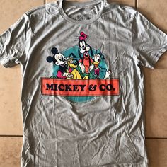 New Without Tags Disney’s Mickey & Co Short Sleeve T-Shirt 50% Cotton 50% Recycled Polyester Disney Character Print Cotton T-shirt, Mickey Mouse Crew Neck T-shirt For Disney Events, Disney Pre-shrunk Short Sleeve T-shirt, Disney Short Sleeve Pre-shrunk T-shirt, Disney Cotton Shirt For Disney Fan Events, Disney T-shirt With Cartoon Print For Disney Trips, Graphic Tee With Character Print For Disney Trips, Fun Letter Print T-shirt For Disney Trips, Disney Trips Character Print Short Sleeve Shirt