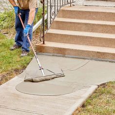 a man is using a mop to clean the sidewalk