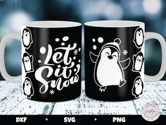 two black and white coffee mugs with penguins on them that say let it snow