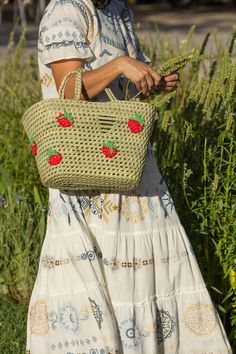 Introducing our Woven Straw Beach Basket, a versatile must-have for your sunny getaway! Inspired by the classic French style shopping basket, this eco-friendly gem is handcrafted from natural fibres, ensuring its durability while keeping sustainability at the forefront. The intricate crochet details add a touch of elegance to this timeless piece, making it ideal for both beach trips and shopping sprees. Its spacious interior offers ample room for all your essentials, while the sturdy handles provide comfort and ease while carrying. Embrace the charm of this woven straw beach basket and let it be your trusted companion for all your adventures. Description: Basket of natural fibre, hand-woven by Argentinian artisans. It has crochet-woven fruits applied all around the basket. Three options: s Natural Straw Bag For Summer Outings And Vacation, Casual Natural Beach Bag For Summer Outings, Natural Crochet Bag For Beach Season Outings, Casual Crochet Bag With Braided Handles For Picnic, Woven Jute Straw Bag For Summer Outings, Casual Basket Crochet Bag For Market, Summer Crochet Bag With Braided Handles For Picnic, Summer Crochet Bag With Braided Natural Fiber, Summer Braided Crochet Bag With Natural Fiber