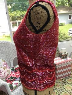 "Vintage 1960s \"GO-GO\" sleeveless beaded/Sequin top. True Red color. Has a full metal zipper in the back with one hook and eye. The tag reads: 100% Wool Hand Beaded in Hong Kong. This top is not lined. CONDITION: Has a small hole in the knit fabric on the right side at the top near the shoulder (SEE PIX). I see a few missing sequins here and here. In the lower back and front (SEE PIX). MEASURES: Bust- 34\"---> 38\" Bottom width-32\"---->36\" Top of shoulder down in the front-21\" In back Red Fitted Tank Top For Party, Red Sleeveless Tops For Party Season, Glamorous Red Sleeveless Top, Festive Sleeveless Dress With Contrast Sequins, Sleeveless Contrast Sequin Festive Dress, Festive Sleeveless Sequin Dress With Contrast, Festive Sleeveless Contrast Sequin Dress, Sleeveless Contrast Sequin Dress For Festive Occasions, Red Sleeveless Tank Top For Evening