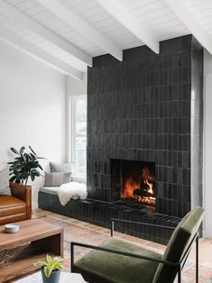 a living room filled with furniture and a fire place in the middle of a fireplace