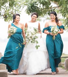 three bridesmaids in green dresses walking together