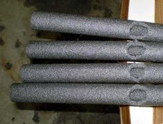 four pieces of gray carpet sitting on top of a wooden table