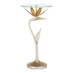 a glass and metal table with a flower on the top, sitting on a white background