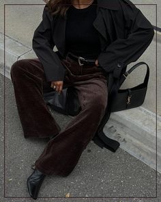 Embrace the chill with a pair of corduroy pants, perfect for fall and winter outfits with a dark academia style touch. We just love this casual outfit with dark chocolate brown corduroy pants, a black trench coat and a YSL hobo bag – you can't go wrong with this color combo.