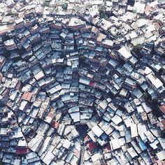 an aerial view of a large city with lots of houses and buildings in the middle