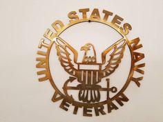 the united states air force emblem is shown in gold and black on a white wall