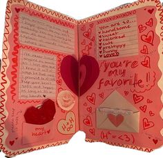 an open valentine's day book with paper hearts