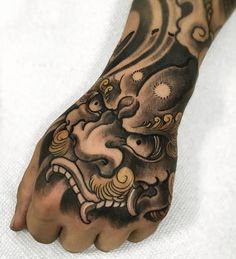 a person's hand with a tattoo on it