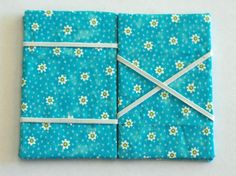 two folded blue cloths with flowers on them