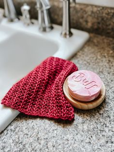 a pink object sitting on top of a counter next to a sink