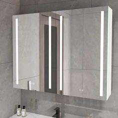 a bathroom with a sink, mirror and lights