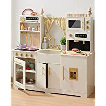 a toy kitchen with white cabinets and gold trim