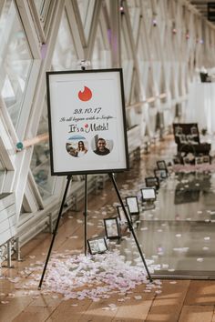 a sign that is standing in the middle of a floor with confetti all over it