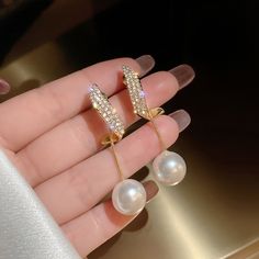 Pearls are the ultimate symbol of sophistication, beauty, and class. Instantly elevate any outfit with these stunning Crystal Erin Pearl Drop Earrings. Gold-plated Artificial white pearl, cubic zirconia crystals Size: 1.8in x 0.5in Pushback stud closure If you aren't in LOVE with your purchase, please let us know within 30 days of receiving your item, and you'll receive a stress-free refund. Pearl Earring Jacket, Pearl Drop Earrings Gold, French Hook Earrings, Fancy Earrings, Baroque Pearl Earrings, Pearl And Diamond Earrings, Vintage Style Jewellery, Girl Jewelry, Silver Pin