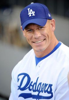 a man in a dodgers uniform smiling for the camera