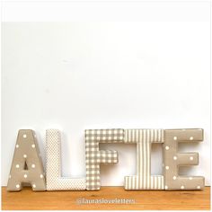 the letters are made out of wood and have polka dots