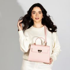 Feminine Pink Top Handle Bag -Chic & Versatile. Introducing our latest collection addition, Layla Bag in Pink. Lean into the femininity of a soft pink bag, perfect for spring and summer. This new-season Enjoy the versatility of Layla Bag with its adjustable strap, allowing you to wear it comfortably as a crossbody or shoulder bag, depending on your style preference. Bag Specifications Material: Vegan leather Interior: Luxurious suede lining Handles: Single handle, Removable shoulder strap Hardware: Golden-tone metal flap Pockets: One inner zipped pocket Closure: Front flap closure Size and Fit- Height: 20 cms / 7.9 In Handle Height: 10 cm / 3.9 In Width at bottom: 26 cm / 10.2 In Depth at bottom: 11 cm / 4.3 In Adjustable strap length: 55-60 cms / 21.7-23.6 ins Feminine Rectangular Bag For On-the-go, Chic Satchel Flap Bag With Removable Pouch, Pink Handheld Bag For On-the-go, Feminine Shoulder Bag With Removable Pouch For On-the-go, Chic Box Bag With Detachable Handle For On-the-go, Chic Travel Flap Bag With Adjustable Handle, Chic Double Handle Flap Bag For Shopping, Chic Flap Bag With Detachable Double Handle, Luxury Bag With Adjustable Strap For Spring