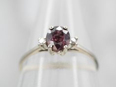 This elegant white gold engagement ring is perfect for any special occasion. It is encrusted with a sparkling pink sapphire and diamond accents, creating a beautiful, eye-catching display. With its timeless design, this ring makes a perfect symbol of love and commitment.Metal: 14K White GoldGem: Pink Sapphire .90 CaratsGem Measurements: 4.7 x 5.4 mm, OvalAccents: 2 Diamonds totaling .03 Carats, SI in Clarity, H in ColorRing Size: 6Marks: "14K" Stamped on the inside band Oval Pink Sapphire Diamond Ring With Accents, Brilliant Cut Pink Sapphire Diamond Ring In White Gold, Classic Pink Sapphire Diamond Ring With Center Stone, Classic Pink Sapphire Ring In Platinum, Classic Pink Sapphire Ring For Formal Occasions, Pink Platinum Diamond Ring For Anniversary, Pink Sapphire Platinum Ring For Wedding, Formal Brilliant Cut Pink Sapphire Rings, Pink Sapphire Platinum Ring For Anniversary