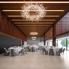 a large room with tables and chairs set up for a formal dinner or function in the center