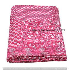 a pink and white blanket with circles on it