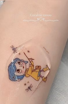 an image of a cartoon character on the side of a woman's leg with tattoos