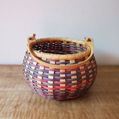 a woven basket sitting on top of a wooden table