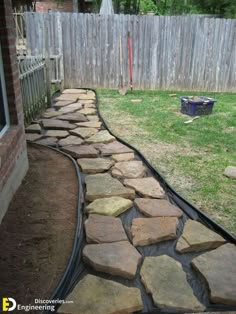 a walkway made out of stones in the yard