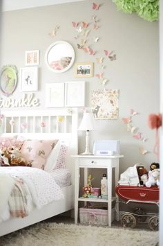 a child's bedroom decorated in white and pink