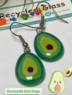 Green Avocado small dangle earrings. Fun Design! These earrings are made of recycled fused glass. The glass is cut, painted and fired in a kiln. When the glass fuses each bead bubbles in its own way becoming an intriguing creation. All the beads are handmade in small batches, please allow slight variations. That is what makes this technique so interesting and beautiful.The glass bead is about 0.65'' white and 0.8'' long. The earrings (hook to bottom are approx 1.6 longSterling silver fish hook wires.All the earrings come with rubber back stoppers. The diameter of the bead is approx .65 inches.The earring is about 1.35 inches long from the hook to the end of the glass.Please like my facebook pagewww.facebook.com/recycledglassjewelry**This is not sea glass, or dichroic glass. We work with fl Playful Hand Painted Dangle Jewelry, Green Resin Fun Earrings, Quirky Multicolor Dangle Jewelry, Quirky Handmade Resin Jewelry, Green Recycled Glass Dangle Earrings, Green Dangle Earrings With Recycled Glass, Green Dangle Earrings In Recycled Glass, Fun Green Polymer Clay Jewelry, Hand Painted Fun Dangle Jewelry