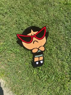 a cartoon character laying in the grass with sunglasses on