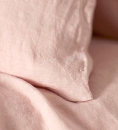 the pink sheets are folded neatly on top of each other in this close up photo