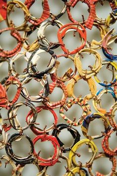 many different colored rings hanging on a wall